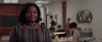 Movie still from “Hidden Figures” (2016), directed by Theodore Melfi – A woman standing in front of a group of people in a room; Close Up shot, Over the shoulder angle