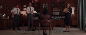 Movie still from “Hidden Figures” (2016), directed by Theodore Melfi – A man and a woman are sitting in front of a desk; Wide shot, Over the shoulder angle