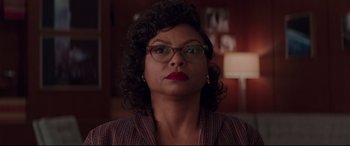 Movie still from “Hidden Figures” (2016), directed by Theodore Melfi – A person wearing glasses and a jacket; Close Up shot, Low angle