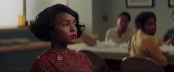 Movie still from “Hidden Figures” (2016), directed by Theodore Melfi – A woman sitting in front of a man in front of a table; Close Up shot, Over the shoulder angle