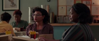 Movie still from “Hidden Figures” (2016), directed by Theodore Melfi – A woman sitting at a table in front of a man; Medium shot, Over the shoulder angle