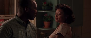Movie still from “Hidden Figures” (2016), directed by Theodore Melfi – A man and a woman standing next to each other in a room; Close Up shot, Over the shoulder angle