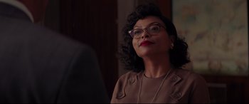 Movie still from “Hidden Figures” (2016), directed by Theodore Melfi – An older woman wearing glasses and a brown jacket; Close Up shot, Over the shoulder angle