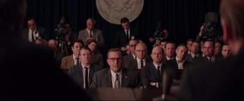 Movie still from “Hidden Figures” (2016), directed by Theodore Melfi – A group of men in suits and ties sitting in a room; Wide shot, Over the shoulder angle