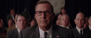 Movie still from “Hidden Figures” (2016), directed by Theodore Melfi – A person wearing a suit and glasses; Close Up shot, Over the shoulder angle
