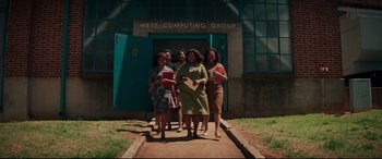 Movie still from “Hidden Figures” (2016), directed by Theodore Melfi – A group of women walking down a sidewalk; Extreme Wide shot, Low angle
