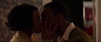 Movie still from “Hidden Figures” (2016), directed by Theodore Melfi – A man and a woman kissing each other; Close Up shot, High angle