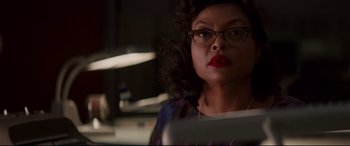 Movie still from “Hidden Figures” (2016), directed by Theodore Melfi – A woman in glasses is looking at a laptop; Close Up shot, Low angle