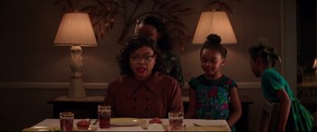 Movie still from “Hidden Figures” (2016), directed by Theodore Melfi – A woman and two children sitting at a table; Medium shot, Over the shoulder angle