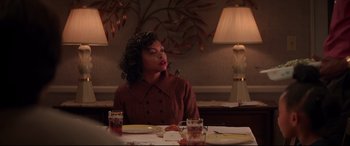 Movie still from “Hidden Figures” (2016), directed by Theodore Melfi – A woman sitting at a table in front of a lamp; Medium shot, Over the shoulder angle
