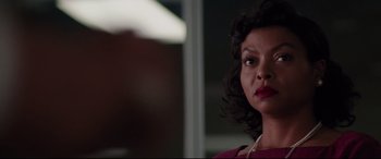 Movie still from “Hidden Figures” (2016), directed by Theodore Melfi – A person wearing a red shirt; Close Up shot, Over the shoulder angle