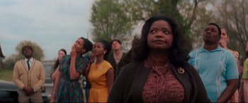 Movie still from “Hidden Figures” (2016), directed by Theodore Melfi – A group of people standing in front of a tree; Medium shot, Low angle