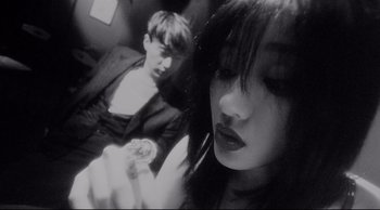 Movie still from “Fallen Angels” (1995), directed by Kar-Wai Wong – A man and a woman sitting next to each other on a train; Close Up shot, Low angle