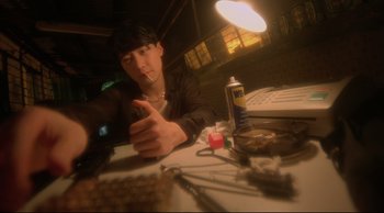 Movie still from “Fallen Angels” (1995), directed by Kar-Wai Wong – A man sitting at a table in front of a computer; Extreme Close Up shot, Low angle