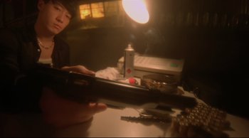 Movie still from “Fallen Angels” (1995), directed by Kar-Wai Wong – A person holding a cell phone in front of a mirror; Close Up shot, High angle