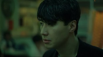Movie still from “Fallen Angels” (1995), directed by Kar-Wai Wong – A young man with black hair looking to his left; Close Up shot, Over the shoulder angle