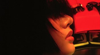 Movie still from “Fallen Angels” (1995), directed by Kar-Wai Wong – A woman's face in the dark; Extreme Close Up shot, Low angle