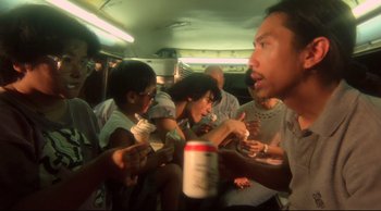 Movie still from “Fallen Angels” (1995), directed by Kar-Wai Wong – A group of people sitting on top of a bus eating food; Medium shot, High angle