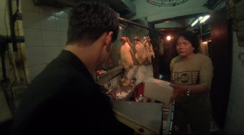 Movie still from “Fallen Angels” (1995), directed by Kar-Wai Wong – A man standing in front of a mirror in a kitchen; Medium shot, Over the shoulder angle