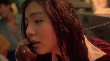 Movie still from “Fallen Angels” (1995), directed by Kar-Wai Wong – A person talking on a cell phone; Close Up shot, High angle