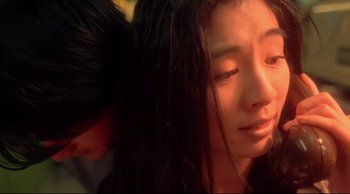 Movie still from “Fallen Angels” (1995), directed by Kar-Wai Wong – A woman with long black hair is looking at the camera; Close Up shot, Low angle