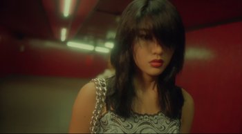 Movie still from “Fallen Angels” (1995), directed by Kar-Wai Wong – A woman with long black hair wearing a white dress; Close Up shot, High angle