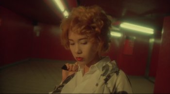 Movie still from “Fallen Angels” (1995), directed by Kar-Wai Wong – A woman with red hair holding a pen in her mouth; Close Up shot, High angle