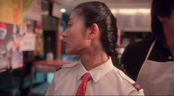Movie still from “Fallen Angels” (1995), directed by Kar-Wai Wong – A woman in a uniform with a red neck tie; Close Up shot, Over the shoulder angle