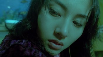 Movie still from “Fallen Angels” (1995), directed by Kar-Wai Wong – A woman's face in a green light; Close Up shot, Overhead angle