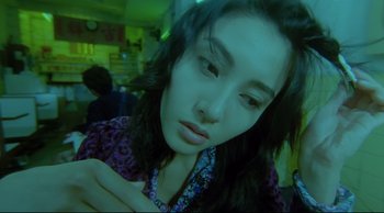 Movie still from “Fallen Angels” (1995), directed by Kar-Wai Wong – A person with long black hair; Close Up shot, Overhead angle