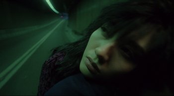 Movie still from “Fallen Angels” (1995), directed by Kar-Wai Wong – A woman with long hair is looking at the camera; Close Up shot, Overhead angle