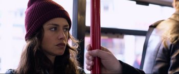 Movie still from “Hitman: Agent 47” (2015), directed by Aleksander Bach – A woman in a red hat holding onto a red pole; Close Up shot, Over the shoulder angle