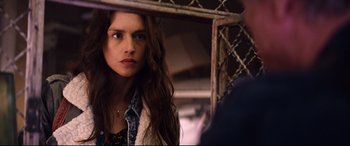 Movie still from “Hitman: Agent 47” (2015), directed by Aleksander Bach – A woman with long brown hair looking at the camera; Close Up shot, Over the shoulder angle