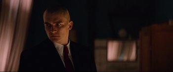 Movie still from “Hitman: Agent 47” (2015), directed by Aleksander Bach – A man in a suit and a red tie; Close Up shot, Low angle
