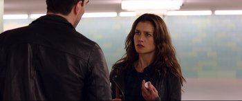 Movie still from “Hitman: Agent 47” (2015), directed by Aleksander Bach – A woman in a leather jacket talking to a man in a leather jacket; Medium shot, Over the shoulder angle