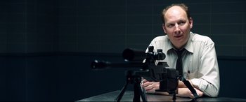 Movie still from “Hitman: Agent 47” (2015), directed by Aleksander Bach – A man sitting in front of a camera; Medium shot, Over the shoulder angle