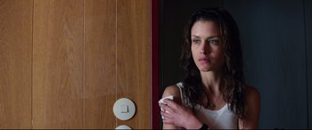 Movie still from “Hitman: Agent 47” (2015), directed by Aleksander Bach – A beautiful woman holding a remote in her hand; Close Up shot, Low angle