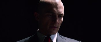 Movie still from “Hitman: Agent 47” (2015), directed by Aleksander Bach – A man in a suit and tie looking to his left; Close Up shot, Low angle