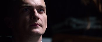 Movie still from “Hitman: Agent 47” (2015), directed by Aleksander Bach – A man's face looking upward; Close Up shot, Low angle