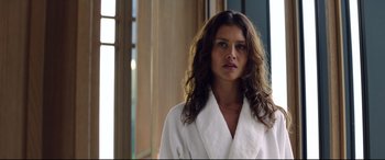 Movie still from “Hitman: Agent 47” (2015), directed by Aleksander Bach – A woman in a white bathrobe standing next to a window; Close Up shot, Low angle