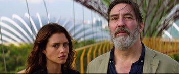 Movie still from “Hitman: Agent 47” (2015), directed by Aleksander Bach – A man and a woman standing next to each other in front of a bridge; Close Up shot, Low angle