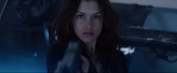 Movie still from “Hitman: Agent 47” (2015), directed by Aleksander Bach – A person holding a gun; Close Up shot, Over the shoulder angle