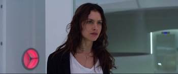 Movie still from “Hitman: Agent 47” (2015), directed by Aleksander Bach – A beautiful woman with long brown hair wearing a white shirt; Close Up shot, Low angle