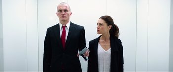 Movie still from “Hitman: Agent 47” (2015), directed by Aleksander Bach – A man and a woman in a suit and red tie; Medium shot, Low angle