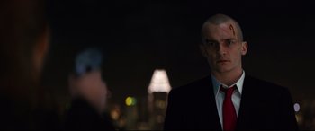 Movie still from “Hitman: Agent 47” (2015), directed by Aleksander Bach – A man in a black suit and white shirt; Close Up shot, Over the shoulder angle