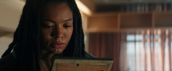 Movie still from “Gen V” (2023), created by Eric Kripke – A woman with dreads looking down at a book; Close Up shot, Low angle