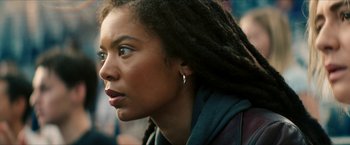 Movie still from “Gen V” (2023), created by Eric Kripke – A person with dreads looking to the side; Close Up shot, Low angle