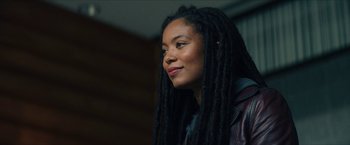 Movie still from “Gen V” (2023), created by Eric Kripke – A person with dreadlocks wearing a jacket; Close Up shot, Low angle