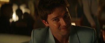 Movie still from “Gen V” (2023), created by Eric Kripke – A person wearing a suit; Close Up shot, Over the shoulder angle