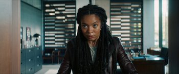 Movie still from “Gen V” (2023), created by Eric Kripke – A woman with dreads and a leather jacket; Close Up shot, Low angle
